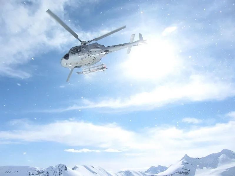 Helicopter above the Swiss Alps during a guided Summit Club ski adventure